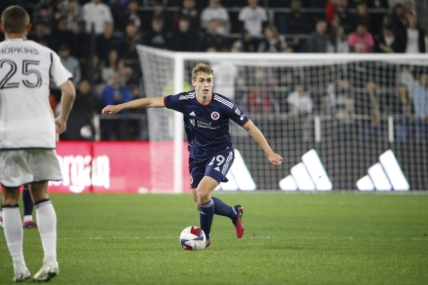 Mar 25, 2023; Washington, District of Columbia, USA; New England Revolution midfielder Noel Buck (29) controls the ball in front of D.C. United midfielder Jackson Hopkins (25) in the first half at Audi Field. Mandatory Credit: Amber Searls-USA TODAY Sports