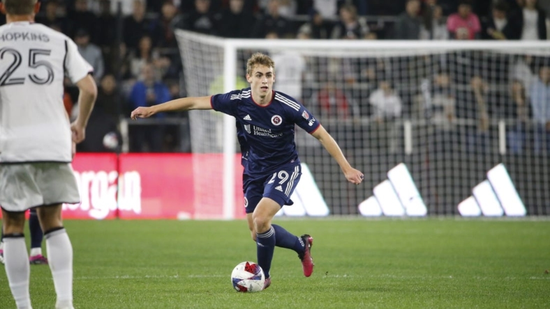 Mar 25, 2023; Washington, District of Columbia, USA; New England Revolution midfielder Noel Buck (29) controls the ball in front of D.C. United midfielder Jackson Hopkins (25) in the first half at Audi Field. Mandatory Credit: Amber Searls-USA TODAY Sports