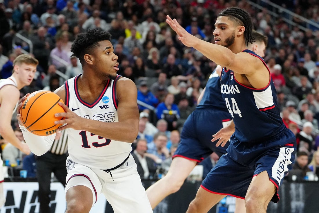 Mar 25, 2023; Las Vegas, NV, USA; Gonzaga Bulldogs guard Malachi Smith (13) grabs a rebound against Connecticut Huskies guard Andre Jackson Jr. (44) during the first half in the NCAA tournament West Regional final at T-Mobile Arena. Mandatory Credit: Stephen R. Sylvanie-USA TODAY Sports
