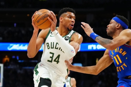 Mar 25, 2023; Denver, Colorado, USA; Milwaukee Bucks forward Giannis Antetokounmpo (34) and Denver Nuggets forward Bruce Brown (11) during the second quarter at Ball Arena. Mandatory Credit: Ron Chenoy-USA TODAY Sports