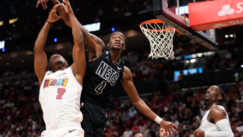 Mar 25, 2023; Miami, Florida, USA; Miami Heat guard Kyle Lowry (7) and Brooklyn Nets guard Edmond Sumner (4) compete for a rebound during the second half at Miami-Dade Arena. Mandatory Credit: Rich Storry-USA TODAY Sports
