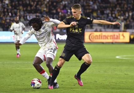 Mar 25, 2023; Los Angeles, California, USA; FC Dallas midfielder Ema Twumasi (22) and Los Angeles FC forward Stipe Biuk (7) battle for the ball in the first half at BMO Stadium. Mandatory Credit: Jayne Kamin-Oncea-USA TODAY Sports