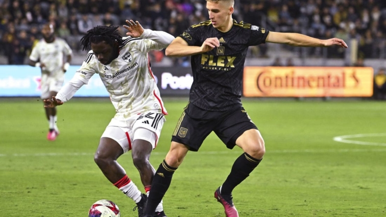 Mar 25, 2023; Los Angeles, California, USA; FC Dallas midfielder Ema Twumasi (22) and Los Angeles FC forward Stipe Biuk (7) battle for the ball in the first half at BMO Stadium. Mandatory Credit: Jayne Kamin-Oncea-USA TODAY Sports
