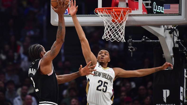 Mar 25, 2023; Los Angeles, California, USA; Los Angeles Clippers forward Kawhi Leonard (2) shoots against New Orleans Pelicans guard Trey Murphy III (25) during the first half at Crypto.com Arena. Mandatory Credit: Gary A. Vasquez-USA TODAY Sports