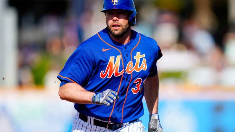 Mar 26, 2023; Port St. Lucie, Florida, USA; New York Mets first baseman Darin Ruf (33) runs into third base against the Miami Marlins during the second inning at Clover Park. Mandatory Credit: Rich Storry-USA TODAY Sports