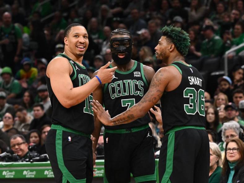 Mar 26, 2023; Boston, Massachusetts, USA; Boston Celtics forward Grant Williams (12), guard Jaylen Brown (7), and guard Marcus Smart (36) talk during a timeout during a game against the San Antonio Spurs at the TD Garden. Mandatory Credit: Brian Fluharty-USA TODAY Sports
