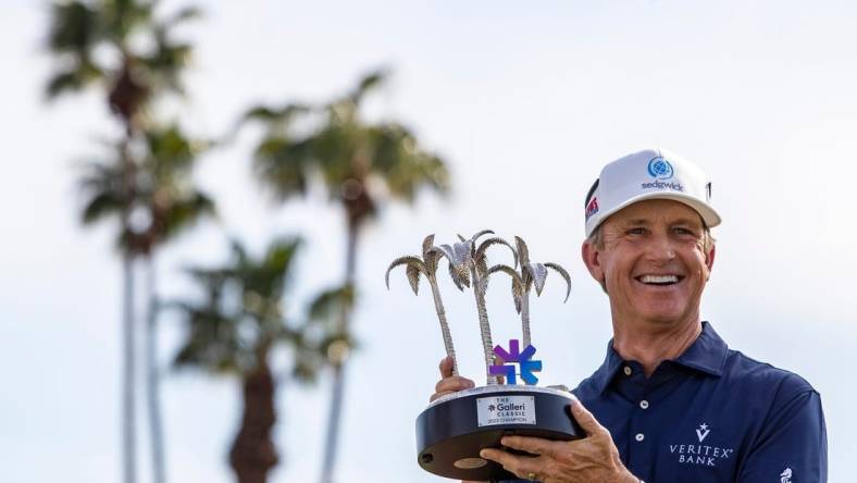 PGA TOUR Champions player David Toms holds up the Galleri Classic trophy after winning the inaugural playing of the tournament on the Dinah Shore Tournament Course in Rancho Mirage, Calif., Sunday, March 26, 2023. Toms finished 16-under overall after hitting 7-under for the final round.