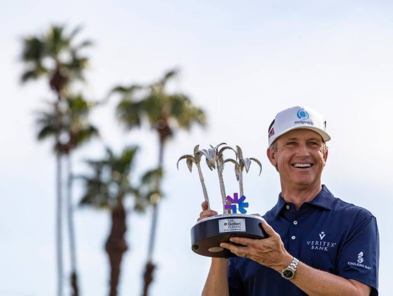 PGA TOUR Champions player David Toms holds up the Galleri Classic trophy after winning the inaugural playing of the tournament on the Dinah Shore Tournament Course in Rancho Mirage, Calif., Sunday, March 26, 2023. Toms finished 16-under overall after hitting 7-under for the final round.