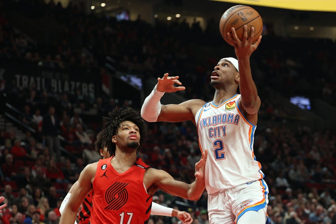 Mar 26, 2023; Portland, Oregon, USA;  Oklahoma City Thunder guard Shai Gilgeous-Alexander (2) shoots the ball over Portland Trail Blazers guard Shaedon Sharpe (17) in the first half at Moda Center. Mandatory Credit: Jaime Valdez-USA TODAY Sports