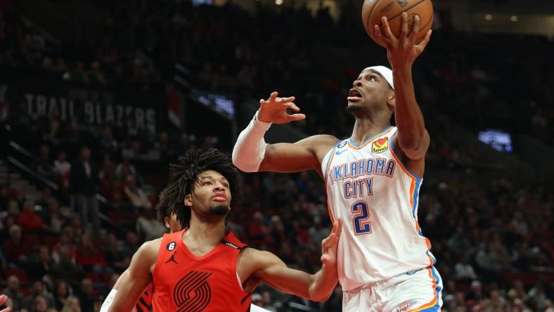 Mar 26, 2023; Portland, Oregon, USA;  Oklahoma City Thunder guard Shai Gilgeous-Alexander (2) shoots the ball over Portland Trail Blazers guard Shaedon Sharpe (17) in the first half at Moda Center. Mandatory Credit: Jaime Valdez-USA TODAY Sports