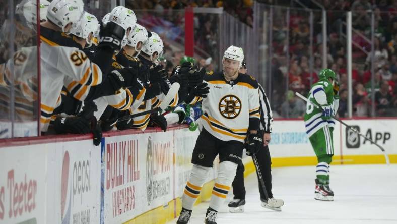 Mar 26, 2023; Raleigh, North Carolina, USA;  Boston Bruins center Charlie Coyle (13) scores a shoot out goal against the Carolina Hurricanes (31) at PNC Arena. Mandatory Credit: James Guillory-USA TODAY Sports