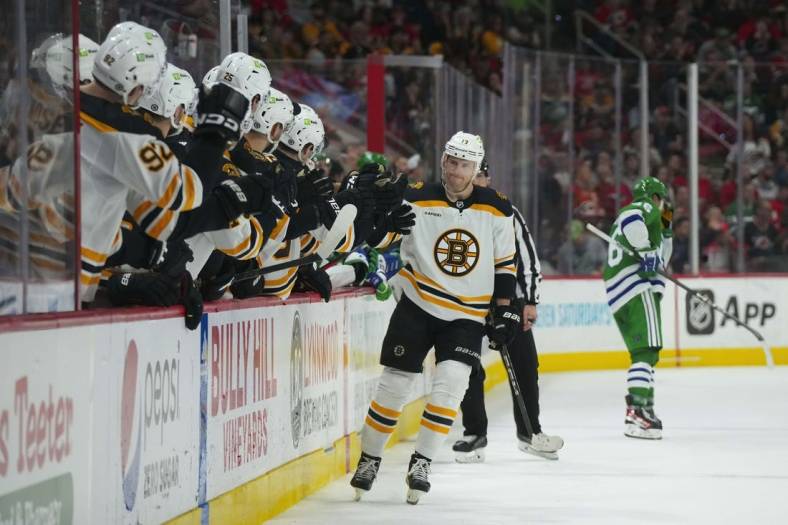 Mar 26, 2023; Raleigh, North Carolina, USA;  Boston Bruins center Charlie Coyle (13) scores a shoot out goal against the Carolina Hurricanes (31) at PNC Arena. Mandatory Credit: James Guillory-USA TODAY Sports