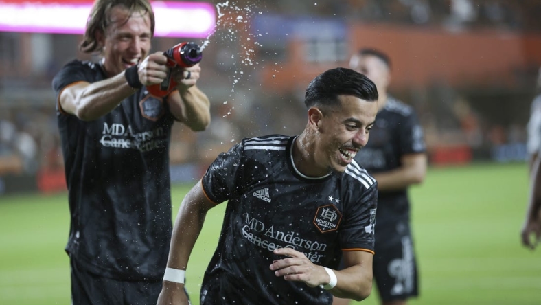 Mar 25, 2023; Houston, Texas, USA; Houston Dynamo midfielder Amine Bassi (8) is squirted with water after the match against the New York City FC at Shell Energy Stadium. Mandatory Credit: Troy Taormina-USA TODAY Sports