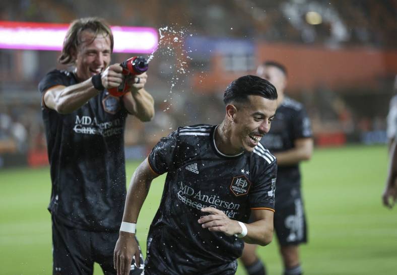Mar 25, 2023; Houston, Texas, USA; Houston Dynamo midfielder Amine Bassi (8) is squirted with water after the match against the New York City FC at Shell Energy Stadium. Mandatory Credit: Troy Taormina-USA TODAY Sports