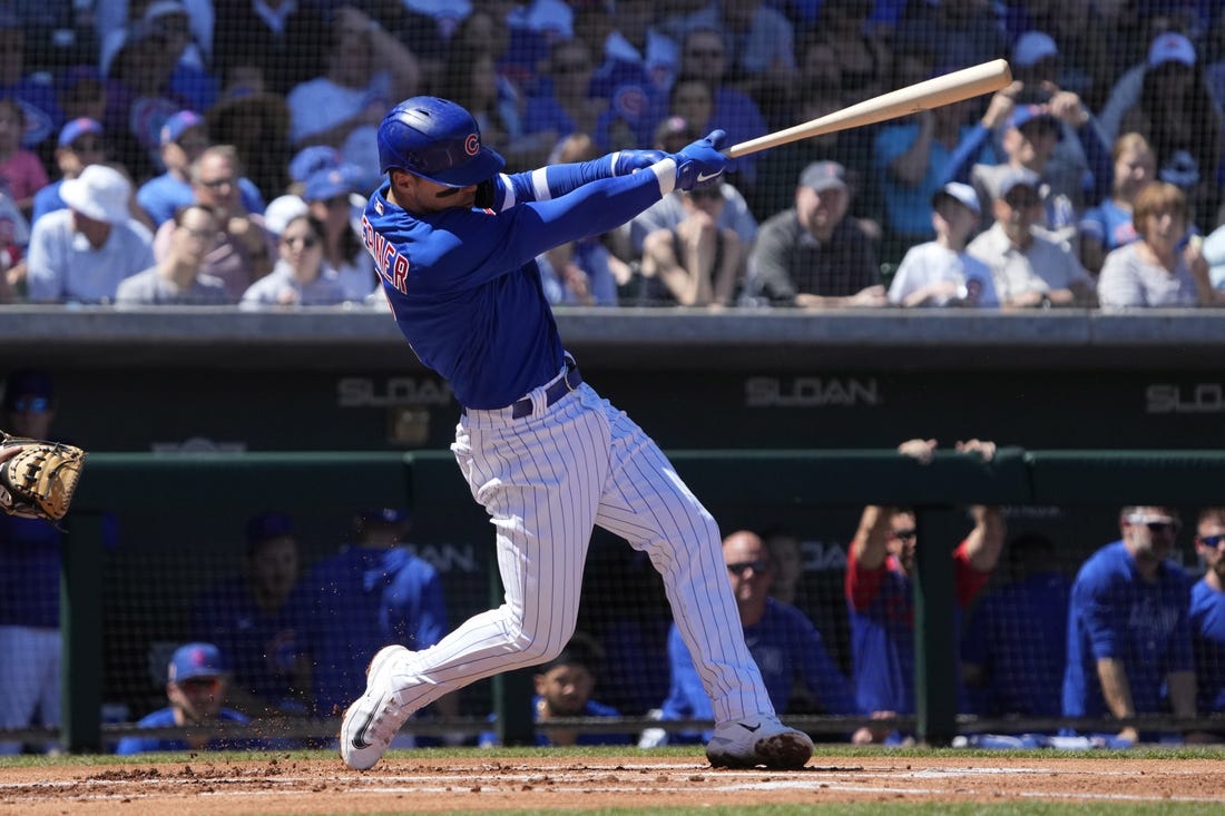 Mar 27, 2023; Mesa, Arizona, USA; Chicago Cubs shortstop Nico Hoerner (2) hits a single against the Chicago White Sox in the first inning at Sloan Park. Mandatory Credit: Rick Scuteri-USA TODAY Sports