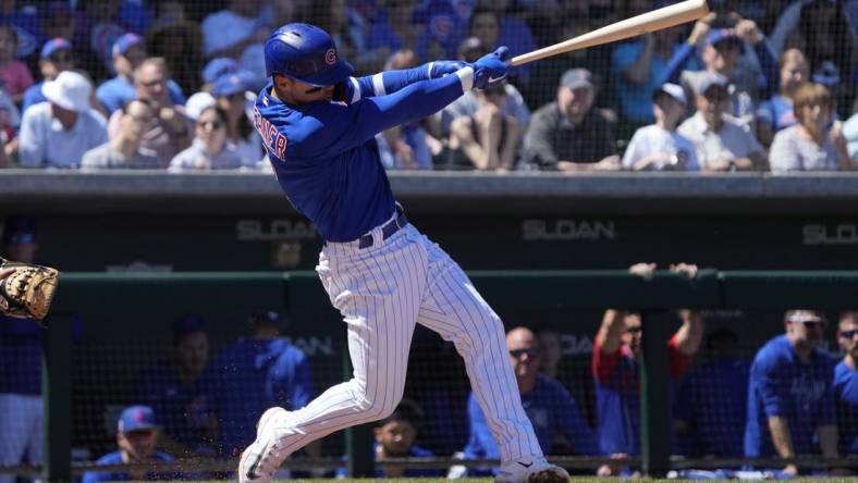 Mar 27, 2023; Mesa, Arizona, USA; Chicago Cubs shortstop Nico Hoerner (2) hits a single against the Chicago White Sox in the first inning at Sloan Park. Mandatory Credit: Rick Scuteri-USA TODAY Sports