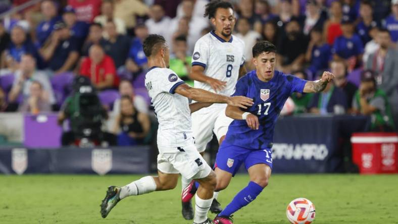 Mar 27, 2023; Orlando, Florida, USA; El Salvador midfielder Narciso Orellana (6) and El Salvador midfielder Bryan Landaverde (8) battle United States of America forward Alex Zendejas (17) for the ball during the first half at Exploria Stadium. Mandatory Credit: Reinhold Matay-USA TODAY Sports