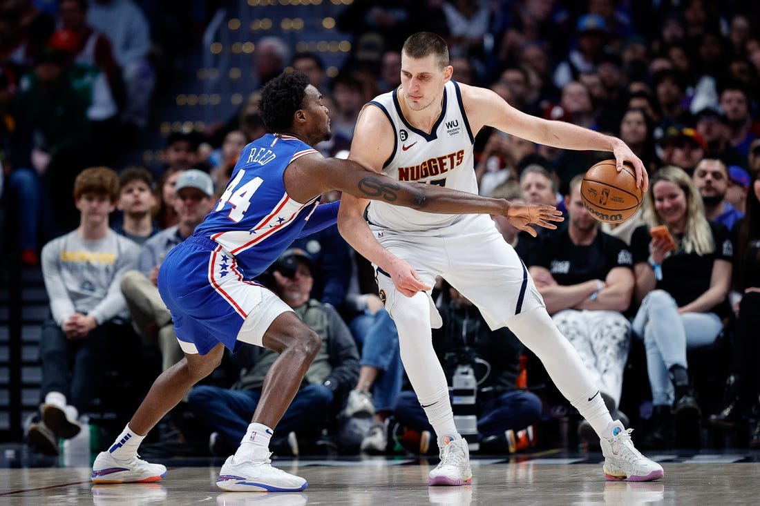 Mar 27, 2023; Denver, Colorado, USA; Denver Nuggets center Nikola Jokic (15) controls the ball as Philadelphia 76ers forward Paul Reed (44) guards in the third quarter at Ball Arena. Mandatory Credit: Isaiah J. Downing-USA TODAY Sports