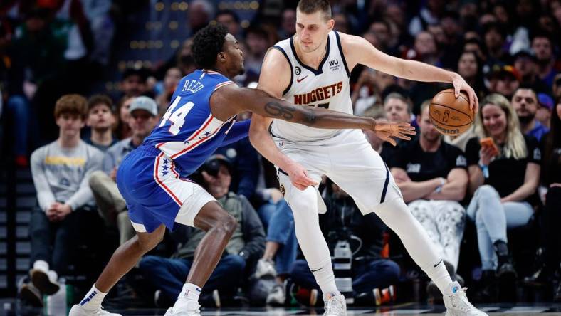 Mar 27, 2023; Denver, Colorado, USA; Denver Nuggets center Nikola Jokic (15) controls the ball as Philadelphia 76ers forward Paul Reed (44) guards in the third quarter at Ball Arena. Mandatory Credit: Isaiah J. Downing-USA TODAY Sports