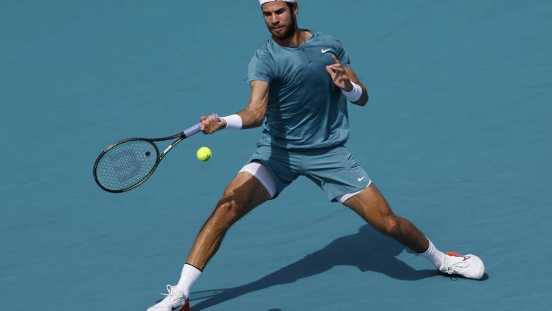 Mar 28, 2023; Miami, Florida, US; Karen Khachanov hits a forehand against Stefanos Tsitsipas (GRE) (not pictured) on day nine of the Miami Open at Hard Rock Stadium. Mandatory Credit: Geoff Burke-USA TODAY Sports