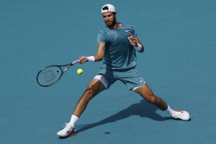 Mar 28, 2023; Miami, Florida, US; Karen Khachanov hits a forehand against Stefanos Tsitsipas (GRE) (not pictured) on day nine of the Miami Open at Hard Rock Stadium. Mandatory Credit: Geoff Burke-USA TODAY Sports