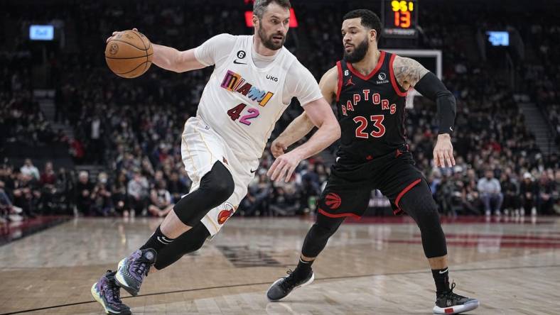 Mar 28, 2023; Toronto, Ontario, CAN; Miami Heat forward Kevin Love (42) drives to the net against Toronto Raptors guard Fred VanVleet (23) during the first half at Scotiabank Arena. Mandatory Credit: John E. Sokolowski-USA TODAY Sports