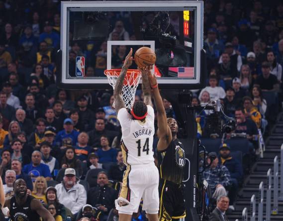 Mar 28, 2023; San Francisco, California, USA; New Orleans Pelicans small forward Brandon Ingram (14) scores a basket against Golden State Warriors forward Jonathan Kuminga (00) during the first quarter at Chase Center. Mandatory Credit: Kelley L Cox-USA TODAY Sports