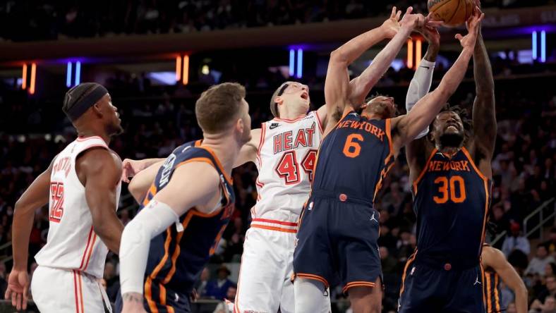 Mar 29, 2023; New York, New York, USA; New York Knicks forward Julius Randle (30) and guard Quentin Grimes (6) and center Isaiah Hartenstein (55) fights for a rebound against Miami Heat center Cody Zeller (44) and forward Jimmy Butler (22) during the first quarter at Madison Square Garden. Mandatory Credit: Brad Penner-USA TODAY Sports