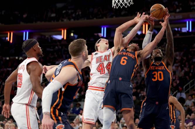 Mar 29, 2023; New York, New York, USA; New York Knicks forward Julius Randle (30) and guard Quentin Grimes (6) and center Isaiah Hartenstein (55) fights for a rebound against Miami Heat center Cody Zeller (44) and forward Jimmy Butler (22) during the first quarter at Madison Square Garden. Mandatory Credit: Brad Penner-USA TODAY Sports