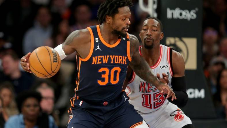 Mar 29, 2023; New York, New York, USA; New York Knicks forward Julius Randle (30) controls the ball against Miami Heat center Bam Adebayo (13) during the first quarter at Madison Square Garden. Mandatory Credit: Brad Penner-USA TODAY Sports