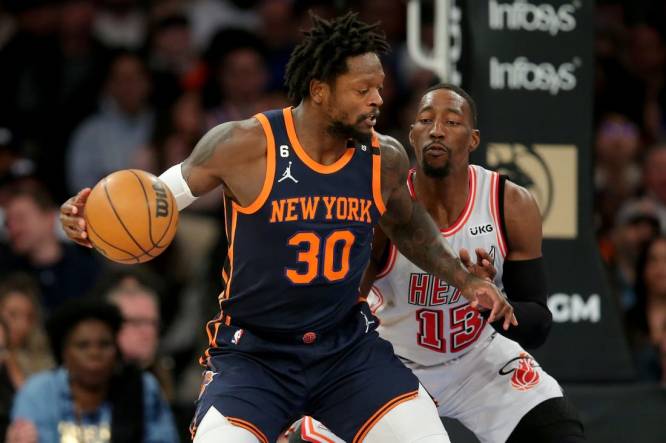 Mar 29, 2023; New York, New York, USA; New York Knicks forward Julius Randle (30) controls the ball against Miami Heat center Bam Adebayo (13) during the first quarter at Madison Square Garden. Mandatory Credit: Brad Penner-USA TODAY Sports