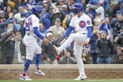 Mar 30, 2023; Chicago, Illinois, USA; Chicago Cubs second baseman Nico Hoerner (2) celebrates with second baseman Miles Mastrobuoni (20) after they both scored against the Milwaukee Brewers during the third inning at Wrigley Field. Mandatory Credit: Kamil Krzaczynski-USA TODAY Sports