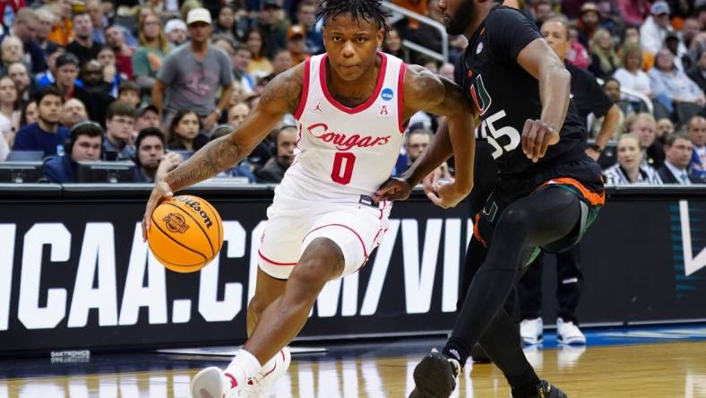 Mar 24, 2023; Kansas City, MO, USA; Houston Cougars guard Marcus Sasser (0) drives against Miami (Fl) Hurricanes guard Wooga Poplar (55) during the second half of an NCAA tournament Midwest Regional semifinal at T-Mobile Center. Mandatory Credit: Jay Biggerstaff-USA TODAY Sports