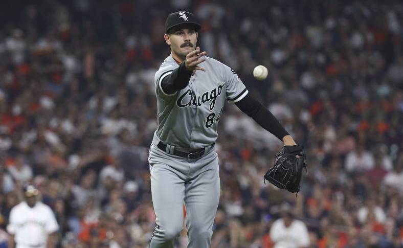 Mar 30, 2023; Houston, Texas, USA; Chicago White Sox starting pitcher Dylan Cease (84) tosses the ball to first base for an out during the fourth inning against the Houston Astros at Minute Maid Park. Mandatory Credit: Troy Taormina-USA TODAY Sports