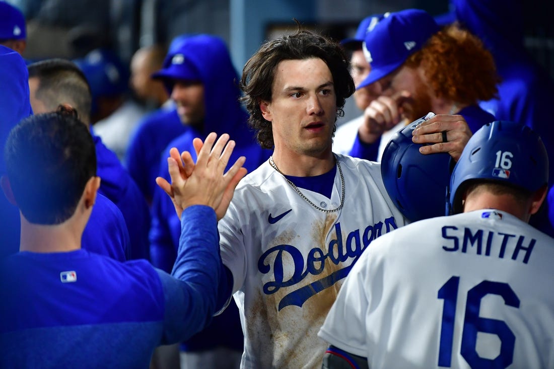 Mar 30, 2023; Los Angeles, California, USA; Los Angeles Dodgers center fielder James Outman (33) is greeted after scoring a run against the Arizona Diamondbacks during the eighth inning at Dodger Stadium. Mandatory Credit: Gary A. Vasquez-USA TODAY Sports