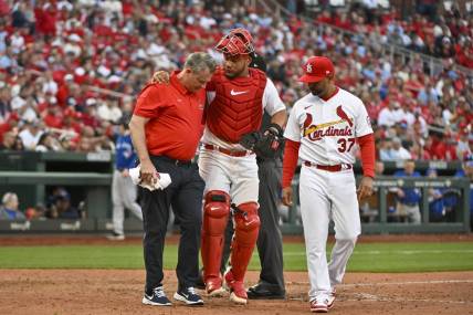 Mar 30, 2023; St. Louis, Missouri, USA;  St. Louis Cardinals catcher Willson Contreras (40) is helped off the field by a trainer after taking a ball off the the knee during the eighth inning against the Toronto Blue Jays at Busch Stadium. Mandatory Credit: Jeff Curry-USA TODAY Sports