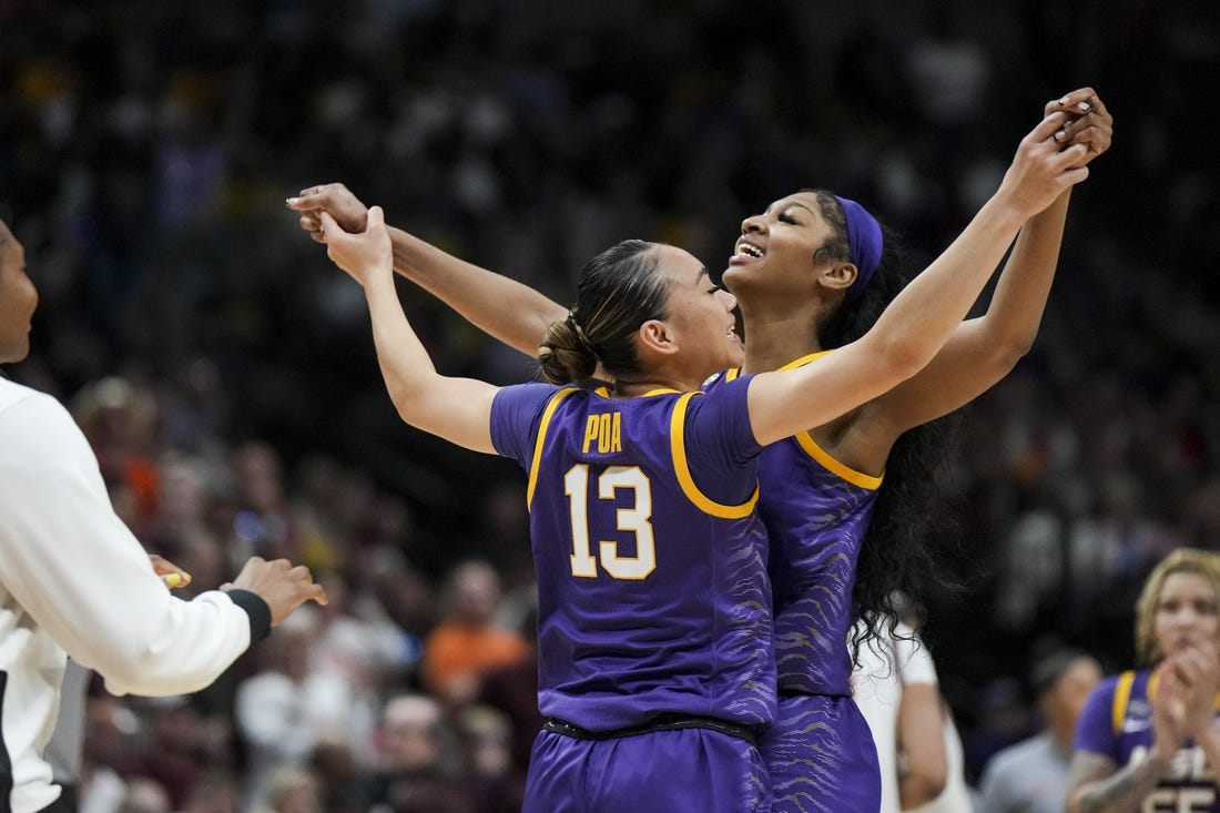 Mar 31, 2023; Dallas, TX, USA; LSU Lady Tigers guard Last-Tear Poa (13) celebrates with forward Angel Reese (10) during a stop in play against the Virginia Tech Hokies in the second half in semifinals of the women's Final Four of the 2023 NCAA Tournament at American Airlines Center. Mandatory Credit: Kirby Lee-USA TODAY Sports
