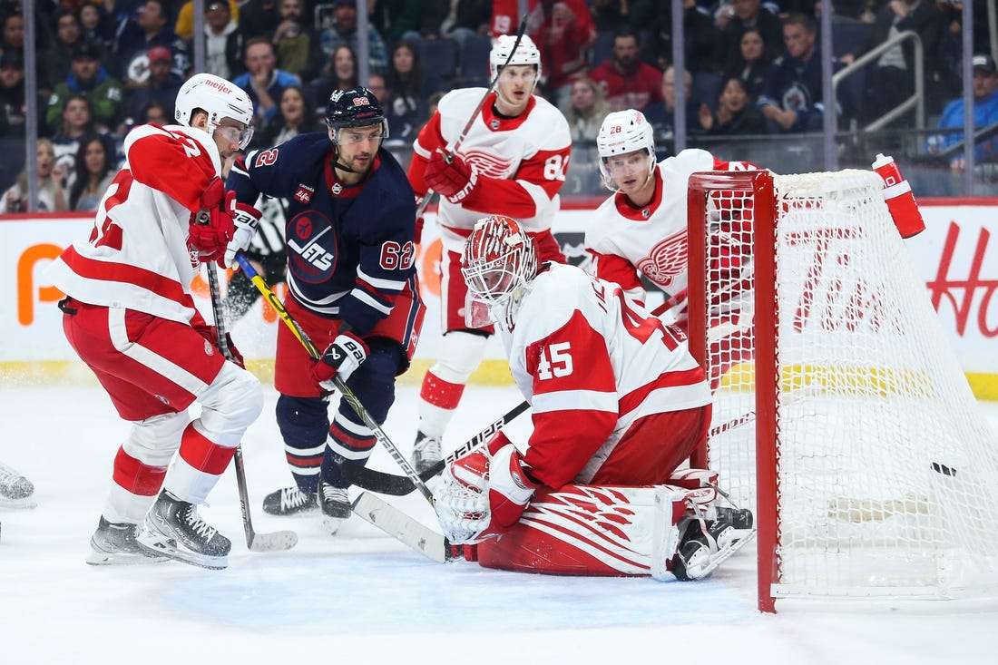 Mar 31, 2023; Winnipeg, Manitoba, CAN;  Winnipeg Jets forward Nino Niederreiter (62) scores on Detroit Red Wings goalie Magnus Hellberg (45) during the second period at Canada Life Centre. Mandatory Credit: Terrence Lee-USA TODAY Sports