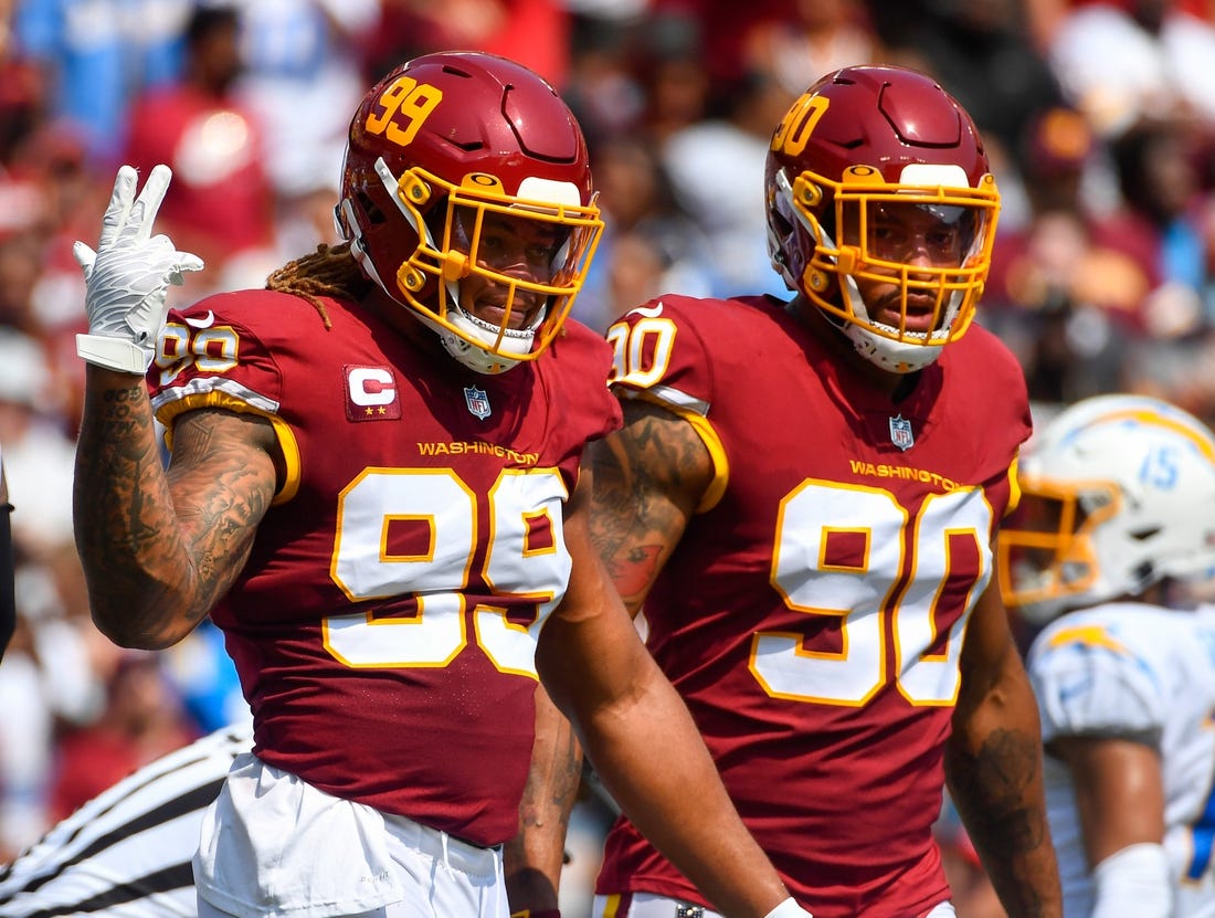 Sep 12, 2021; Landover, Maryland, USA; Washington Football Team defensive end Chase Young (99) and defensive end Montez Sweat (90) on the field against the Los Angeles Chargers during the first quarter at FedExField. Mandatory Credit: Brad Mills-USA TODAY Sports