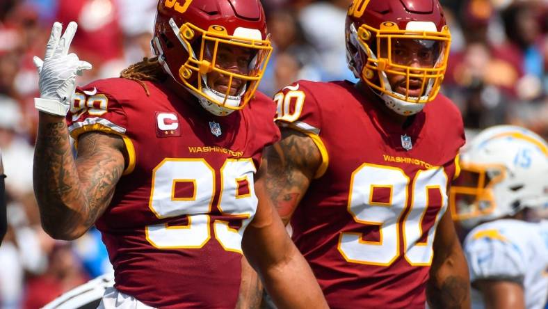 Sep 12, 2021; Landover, Maryland, USA; Washington Football Team defensive end Chase Young (99) and defensive end Montez Sweat (90) on the field against the Los Angeles Chargers during the first quarter at FedExField. Mandatory Credit: Brad Mills-USA TODAY Sports