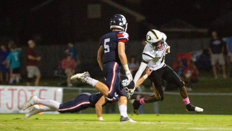 Dadeville's Philstavious Dowdell (7) tries to fend off Trinity's Thompson Mcnees (15) as Seawell Mckee (5) swoops in for a tackle on October 08, 2021.

1008 Trinity V Dadeville