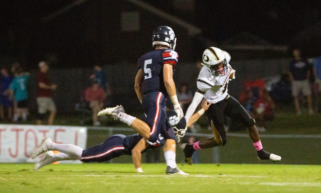 Dadeville's Philstavious Dowdell (7) tries to fend off Trinity's Thompson Mcnees (15) as Seawell Mckee (5) swoops in for a tackle on October 08, 2021.

1008 Trinity V Dadeville