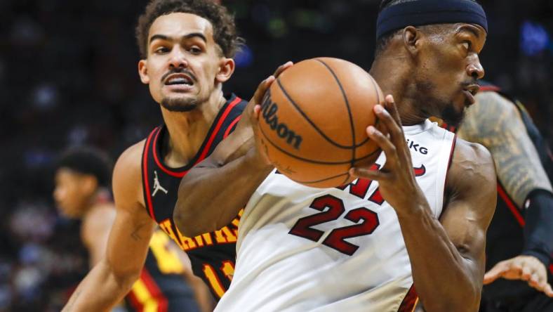 Jan 14, 2022; Miami, Florida, USA; Miami Heat forward Jimmy Butler (22) protects the ball from Atlanta Hawks guard Trae Young (11) during the second quarter of the game at FTX Arena. Mandatory Credit: Sam Navarro-USA TODAY Sports