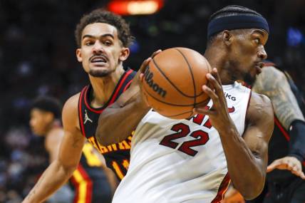 Jan 14, 2022; Miami, Florida, USA; Miami Heat forward Jimmy Butler (22) protects the ball from Atlanta Hawks guard Trae Young (11) during the second quarter of the game at FTX Arena. Mandatory Credit: Sam Navarro-USA TODAY Sports