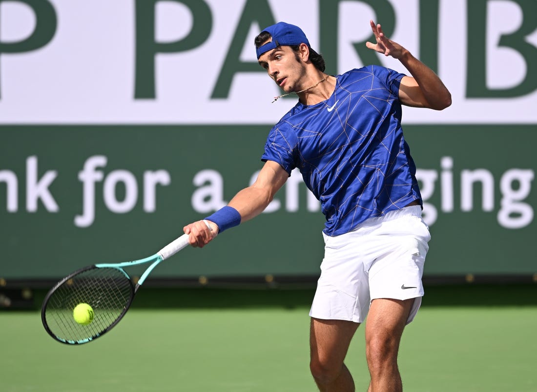 Mar 10, 2022; Indian Wells, CA, USA; Lorenzo Musetti (ITA) hits a shot in his first round match against Marcos Giron (USA) on day 4 at the BNP Paribas Open at the Indian Wells Tennis Garden. Mandatory Credit: Jayne Kamin-Oncea-USA TODAY Sports