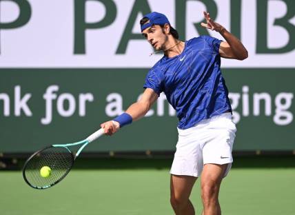 Mar 10, 2022; Indian Wells, CA, USA; Lorenzo Musetti (ITA) hits a shot in his first round match against Marcos Giron (USA) on day 4 at the BNP Paribas Open at the Indian Wells Tennis Garden. Mandatory Credit: Jayne Kamin-Oncea-USA TODAY Sports