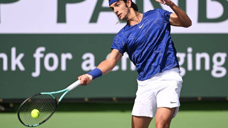 Mar 10, 2022; Indian Wells, CA, USA; Lorenzo Musetti (ITA) hits a shot in his first round match against Marcos Giron (USA) on day 4 at the BNP Paribas Open at the Indian Wells Tennis Garden. Mandatory Credit: Jayne Kamin-Oncea-USA TODAY Sports