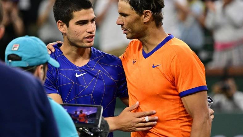 Mar 19, 2022; Indian Wells, CA, USA;  Rafael Nadal (ESP) gripping shakes hands Carlos Alcaraz (ESP) after their semifinal match at the BNP Paribas Open at the Indian Wells Tennis Garden. Mandatory Credit: Jayne Kamin-Oncea-USA TODAY Sports