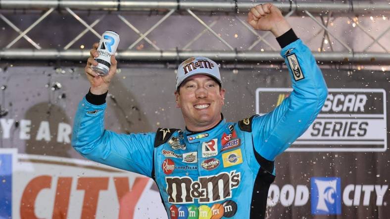 Apr 17, 2022; Bristol, Tennessee, USA; NASCAR Cup Series driver Kyle Busch (18) reacts after winning the Bristol Motor Speedway Dirt Course. Mandatory Credit: Randy Sartin-USA TODAY Sports