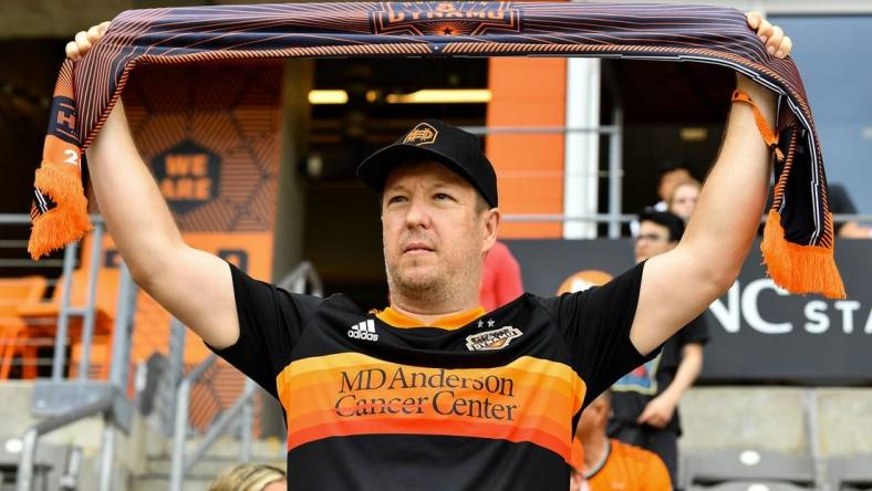 Apr 16, 2022; Houston, Texas, USA;  A fan holds up a scarf in support of the Houston Dynamo FC prior to the match against the Portland Timbers at PNC Stadium. Mandatory Credit: Maria Lysaker-Houston Dynamo-USA TODAY Sports